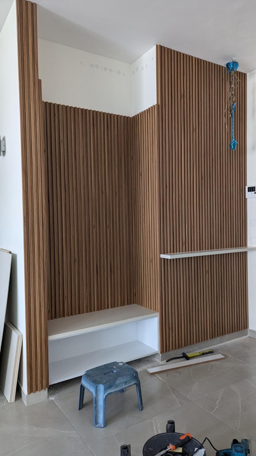 wood slat wall bench installation progress
